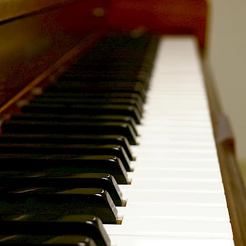 Photo of the keys of a piano from the left, showing all the keys towards the right of the piano.